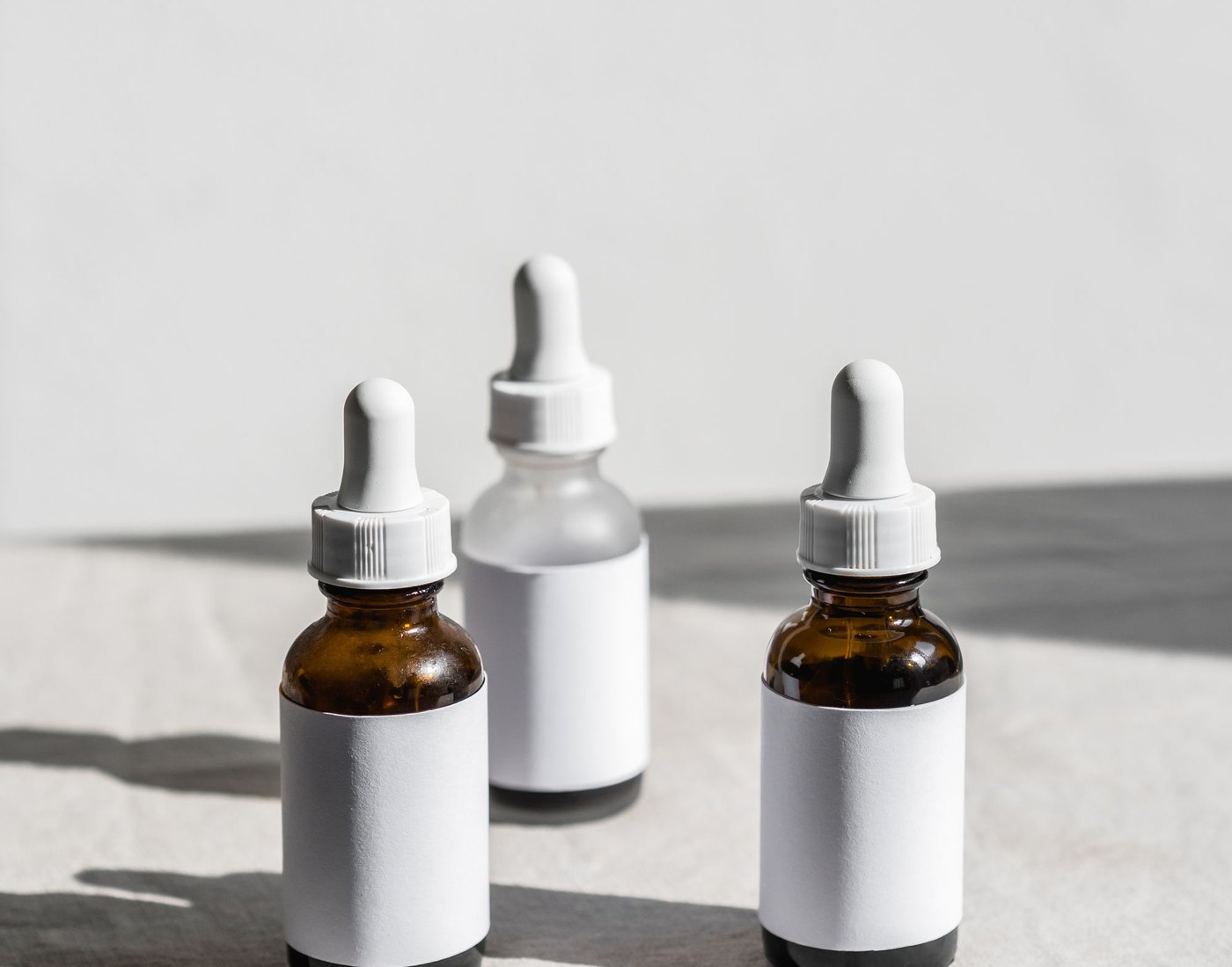 Three LUMANCE dropper bottles in natural light